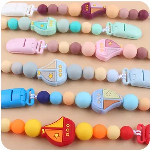 Colorful silicone baby pacifier clips featuring creative sailboat charms for teething relief