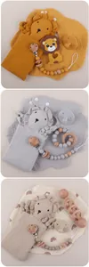 Detailed set of lion baby comforter, pacifier clip, wooden rattle, and muslin bib in gift box