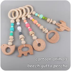 Detail of beech wood and silicone teething pendants with animal and fruit shapes