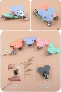 Detail of colorful cartoon bear and mouse silicone baby pacifier clips with steel buckles