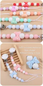 Detail showing soft silicone baby pacifier clip with cute bow shape in macaron colors