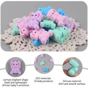 Macro detail of silicone elephant beads for DIY baby pacifier clips in pastel colors