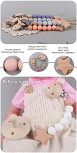 Detail of baby pacifier clip with silicone beads and star-shaped beech wood material