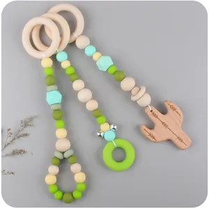 Detail of wooden baby gym pendants with silicone beads and beech wood animal charms