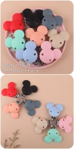 Detailed view of colorful silicone pacifier clips with various cute animal-shaped designs