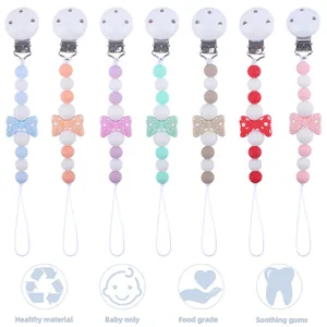 Overview of seven colorful silicone pacifier clips with bows and food grade beads