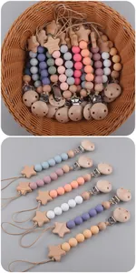Close-up of beech wood star pacifier clip with colorful silicone beads in Morandi tones