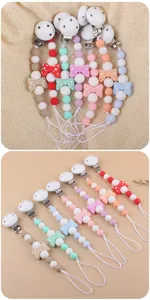 Close-up of silicone pacifier clips with colorful beads and polka dot bow details