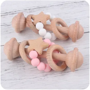 Detailed view of beech wood baby rattle with soft silicone beads and star pendant