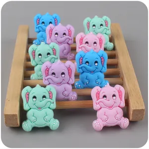 Cartoon elephant silicone teething beads in macaron colors on a wooden display stand