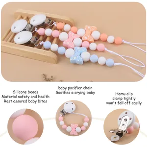 Silicone baby pacifier clips with bow decoration in pink and blue colors