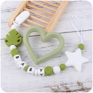 Close-up of baby pacifier clip with forest green silicone beads and BABY letter charms