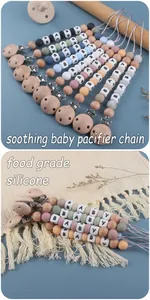 Close-up of food grade silicone and beech wood pacifier clips with BABY letter beads