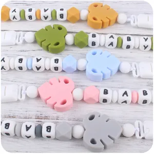 Parallel layout showing five colors of silicone teething pacifier clips with leaf charms