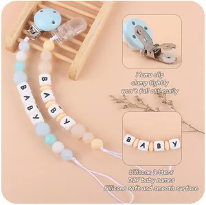 Detail of DIY silicone baby pacifier clips featuring macaron beads and BABY letter cubes