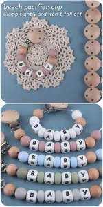 Detail of beech wood pacifier clips with colorful silicone beads in morandi tones