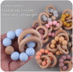 Detail of colorful food-grade silicone beads and natural beech wood rings for baby teething