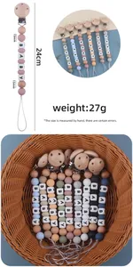 Detailed view of handmade silicone and beech wood baby pacifier clip with 24cm length