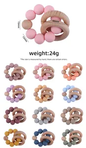 Detail of baby teething bracelet with 15mm silicone beads and 40mm wooden rings