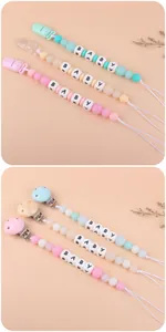 Detailed macro view of silicone baby pacifier clips with pastel beads and BABY lettering
