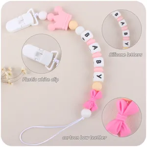 Detail of pink silicone crown and butterfly teether with baby letter beads and clip