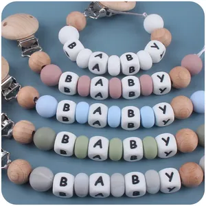 Beech wood and silicone baby pacifier clips in five colors with alphabet beads