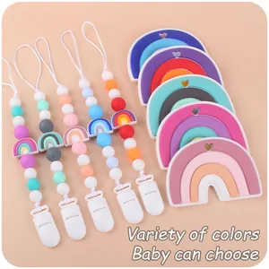 Detail of colorful silicone baby pacifier clips and rainbow teething toys in various hues
