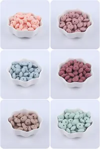Detailed view of lens-shaped silicone beads in assorted Morandi colors for DIY jewelry
