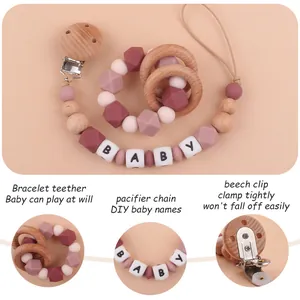Detail view of pink silicone octagonal beads and beech wood rings for baby teething