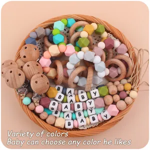 Close-up of DIY baby teether set with silicone beads and beech wood clips in gift basket