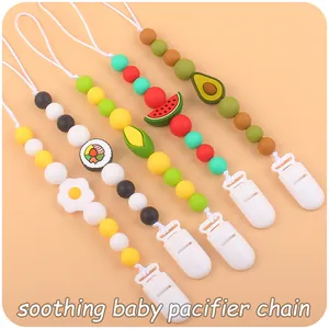 Detailed view of silicone pacifier chains with fruit designs like avocado and watermelon