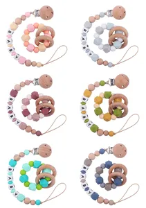 Detailed set of silicone and beech wood pacifier clips and teething rings in six soft colors