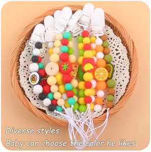 Silicone pacifier clip detail with colorful beads and various food shaped charms