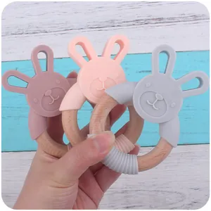 Detail view of silicone bunny teething rings with natural beech wood and textured grips