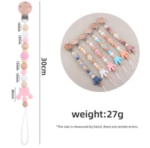 Detail view of beech wood pacifier clip with silicone crown teether and crochet beads