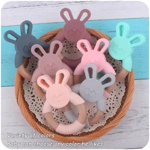 Detail of colorful silicone rabbit teething rings with natural beech wood circles