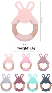 Detail view of rabbit silicone baby teether with beech wood ring showing dimensions and weight