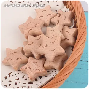 Close-up of star-shaped beech wood beads with smiling faces for DIY pacifier clips