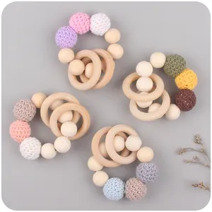 Natural beech wood baby teether set with colorful handmade crochet balls for soothing
