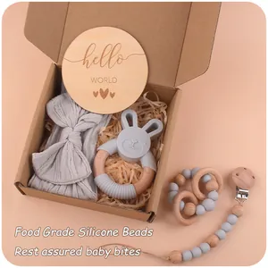 Detail view of baby gift set with rabbit teether and wooden hello world card