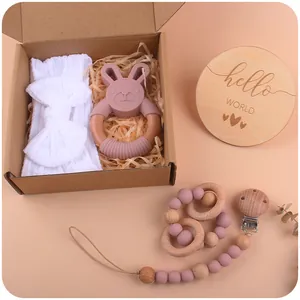 Pink rabbit silicone teether, white bow headband and pacifier clip in a gift box