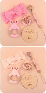 Baby gift set with pink bow headband, rabbit teether, pacifier clip and Hello World card