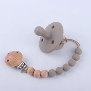 Silicone baby pacifier and matching clip set with natural wood beads in taupe color