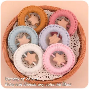 Detail of 6-piece baby woven star teethers in various colors inside a wicker basket