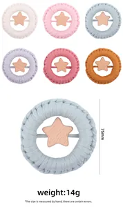 Detail view of a 75mm hand-woven cotton ring baby teether with a wooden star in six colors
