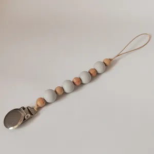 Detail of baby pacifier clip with gray silicone beads and natural wooden accents