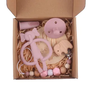 Macro shot of dusty rose silicone baby teether gift set with wooden elephant clips