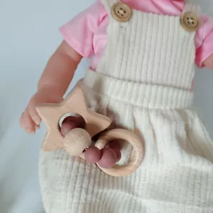 Star-shaped beech wood and pink silicone bead baby teething ring with Nordic design