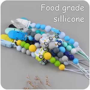 Macro detail of colorful silicone pacifier clips with police car beads for infants