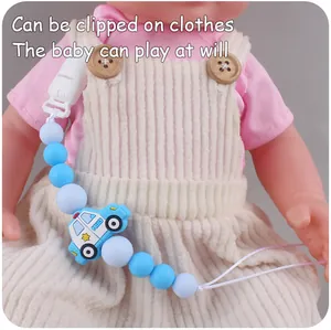 Detailed view of baby pacifier clip featuring blue silicone beads and police car charm